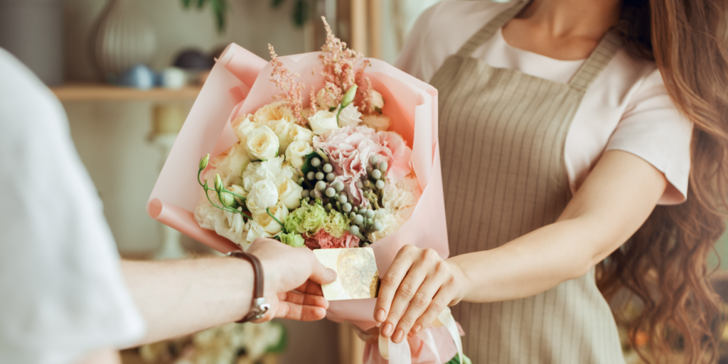 Florist handing customer card