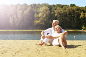 Senior couple resting together on a beach