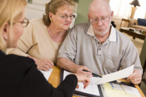 an older couple reading an estate plan from their attorney